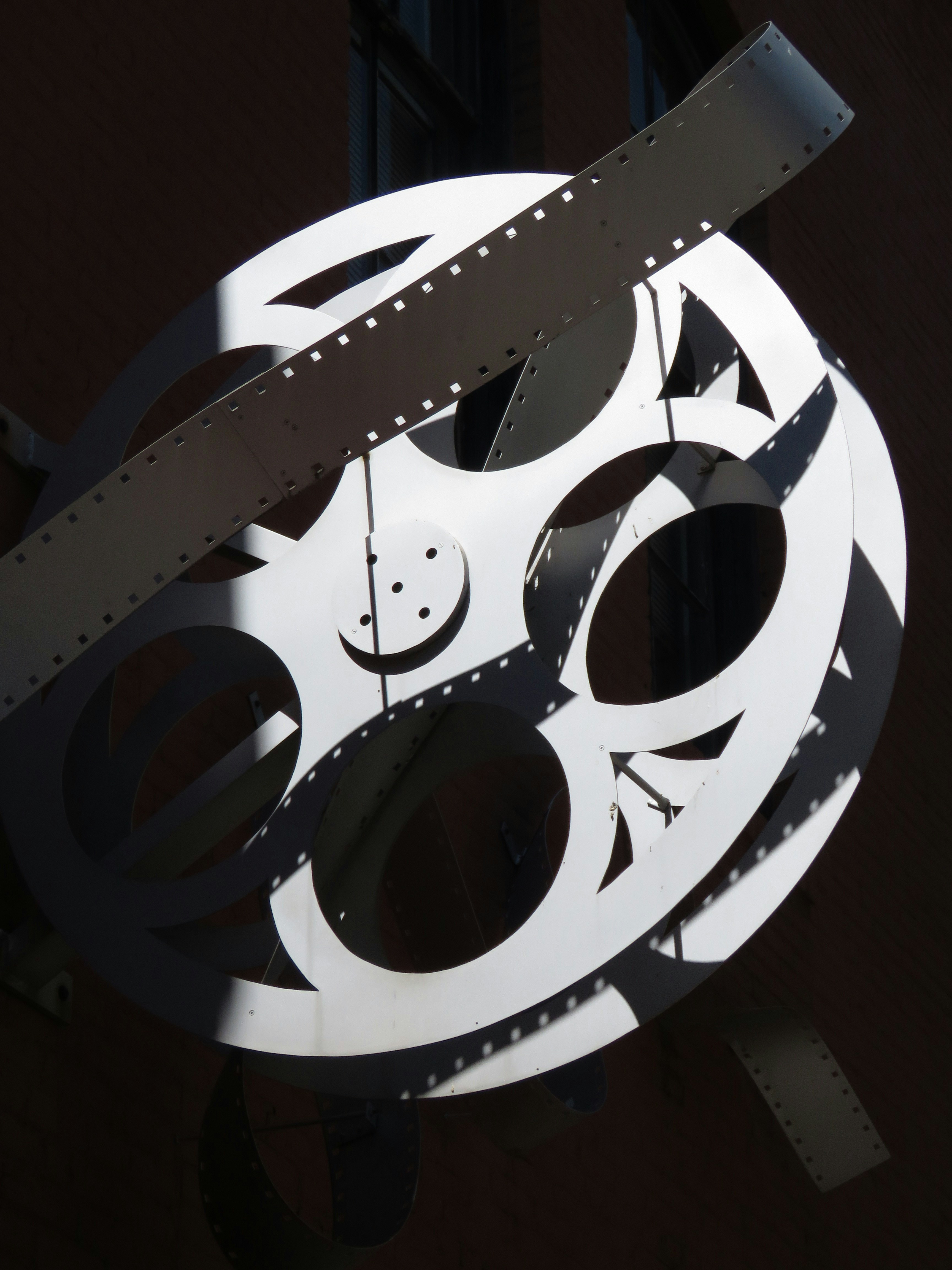 Photograph of a film reel sculpture.